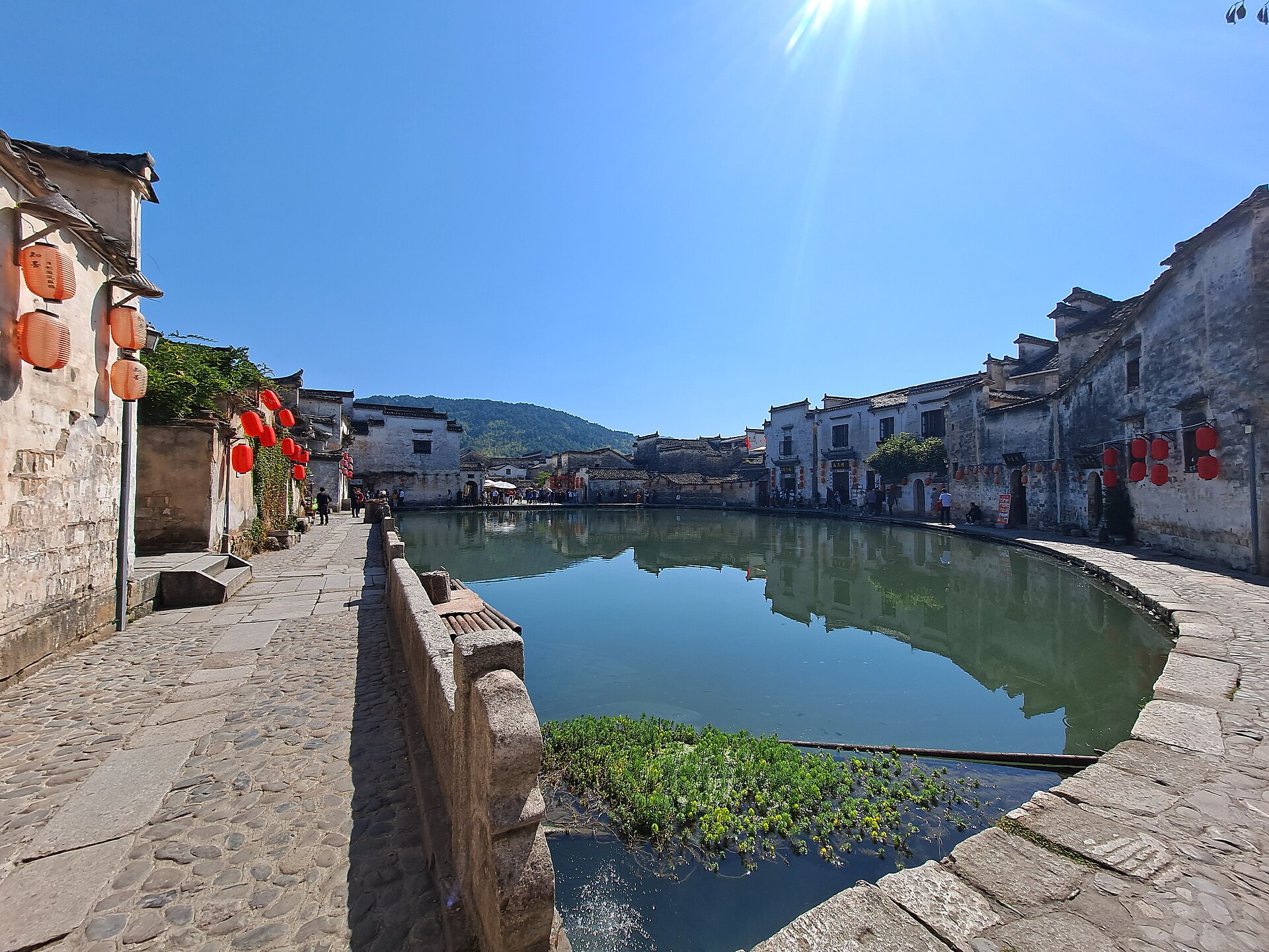 White-walled houses and a narrow stone path around Hongcun’s Moon Pond